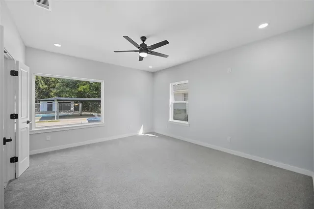 a view of a livingroom with a ceiling fan and window