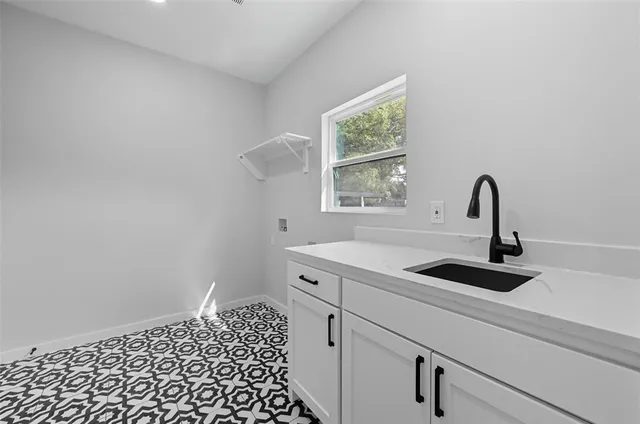 a close view of a sink and dishwasher with a kitchen island