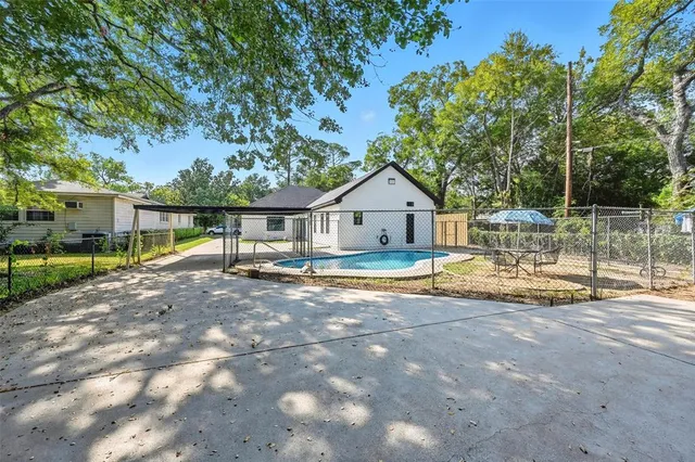 a view of house with outdoor space and swimming pool
