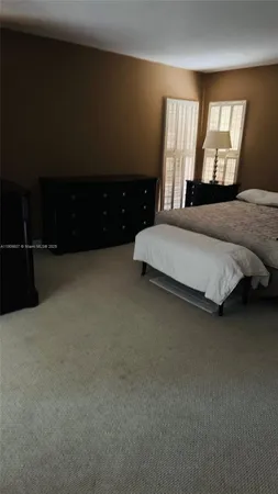 a spacious bedroom with a bed and window