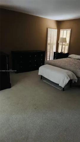 a spacious bedroom with a bed and window