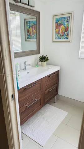 a room with a bed and a dresser