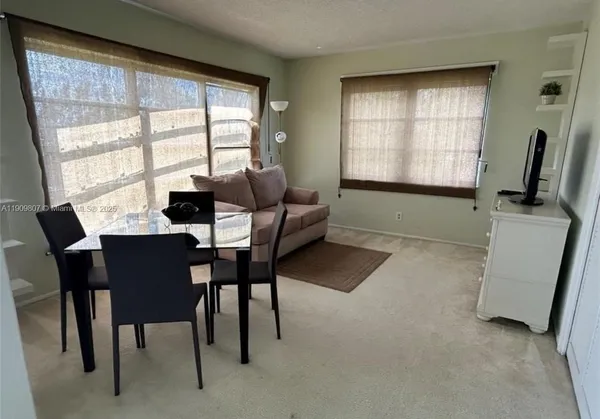 a dining room with furniture and window