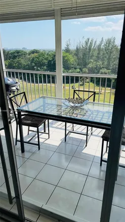 a view of a chairs and table in the balcony