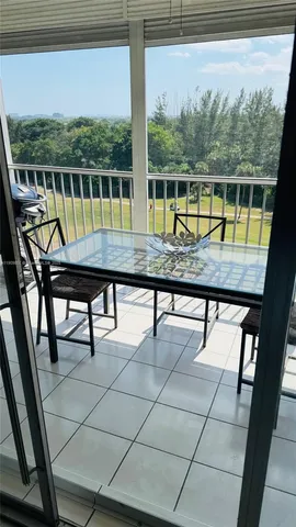 a view of a chairs and table in the balcony