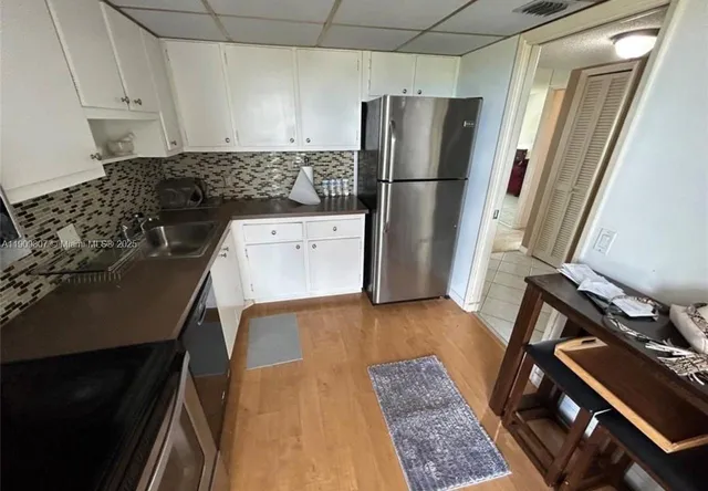 a kitchen with a refrigerator and a stove