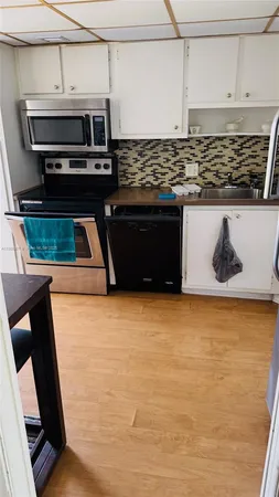a kitchen with stainless steel appliances kitchen island a stove and a refrigerator