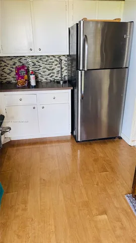 a view of refrigerator and microwave