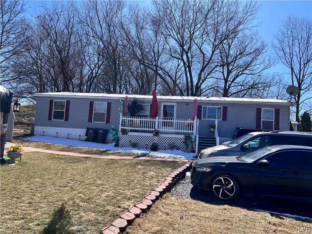 a view of a house with backyard space and sitting area