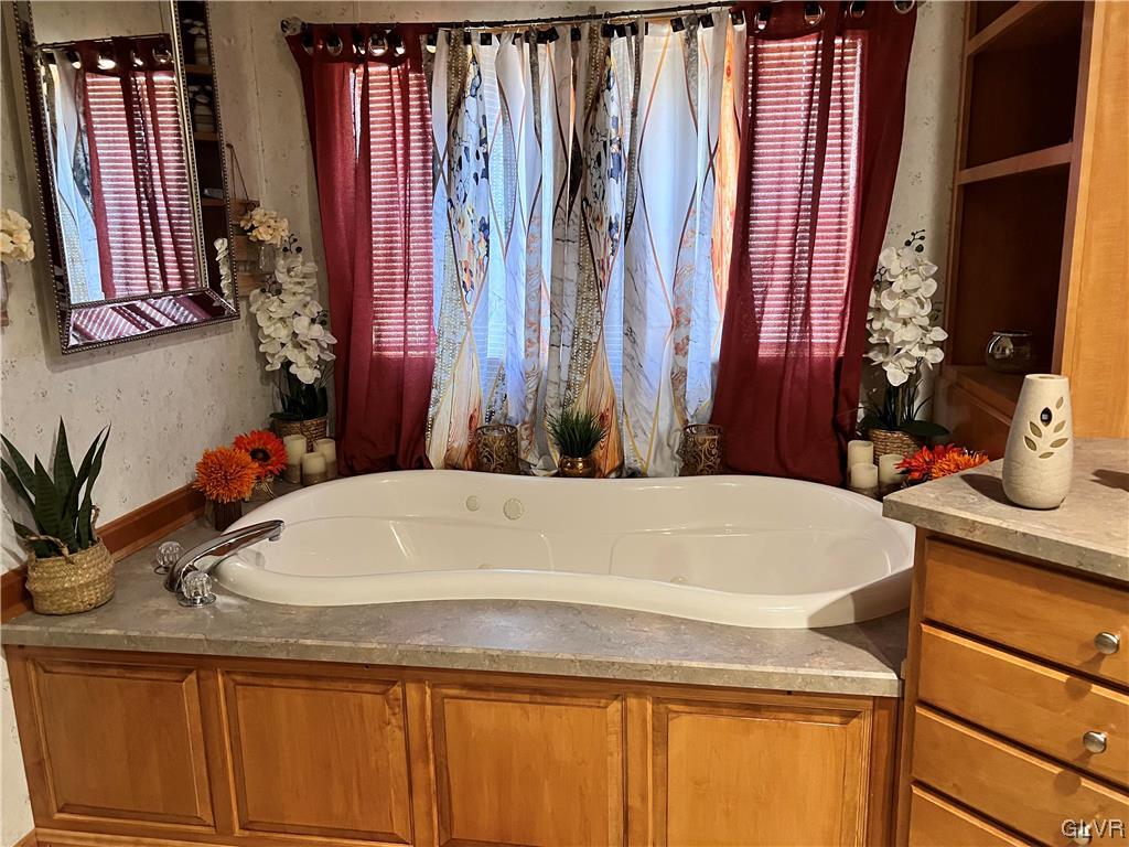 4205 Leopard Circle Orefield, PA 18069 - Photo 13 of 20 a bathroom with a granite countertop sink and a mirror
