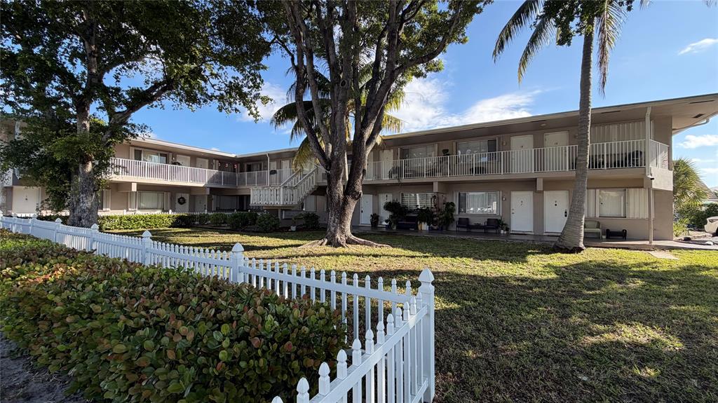 a view of a house with swimming pool and sitting area