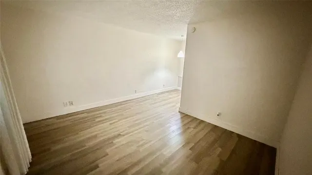 an empty room with wooden floor