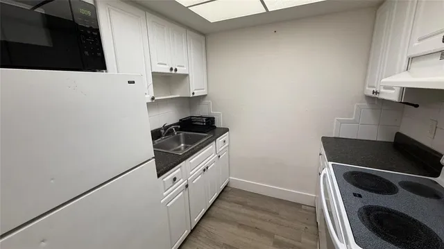 a kitchen with granite countertop cabinets and steel stainless steel appliances