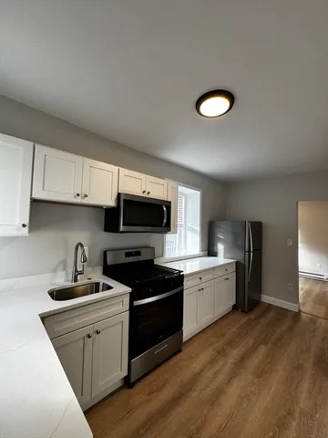 a kitchen with granite countertop a sink and steel appliances