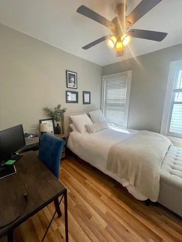 a bedroom with a bed window and couch