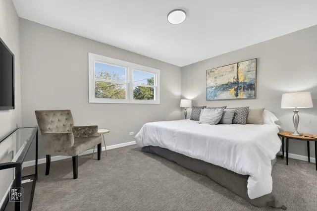 a bedroom with a bed and a lamp on table