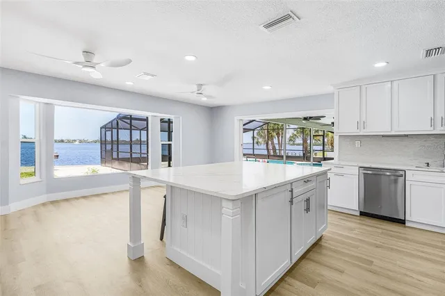 a kitchen with granite countertop a stove and a sink