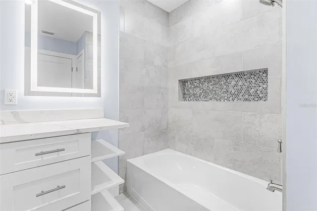 a bathroom with a bathtub and a window