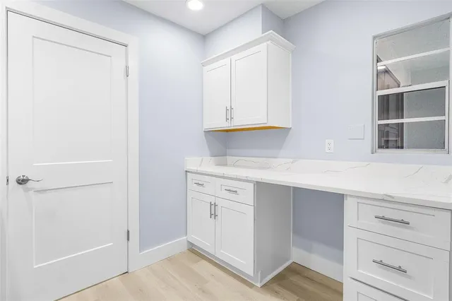 a kitchen with white cabinets and a sink