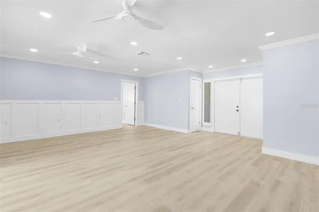 a view of an empty room with wooden floor
