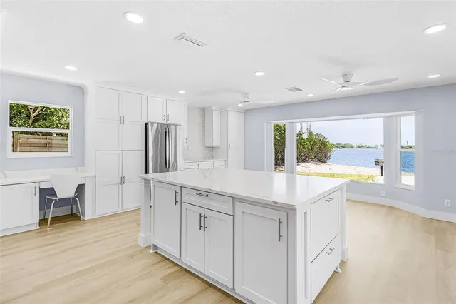 a kitchen with stainless steel appliances granite countertop a sink and a stove