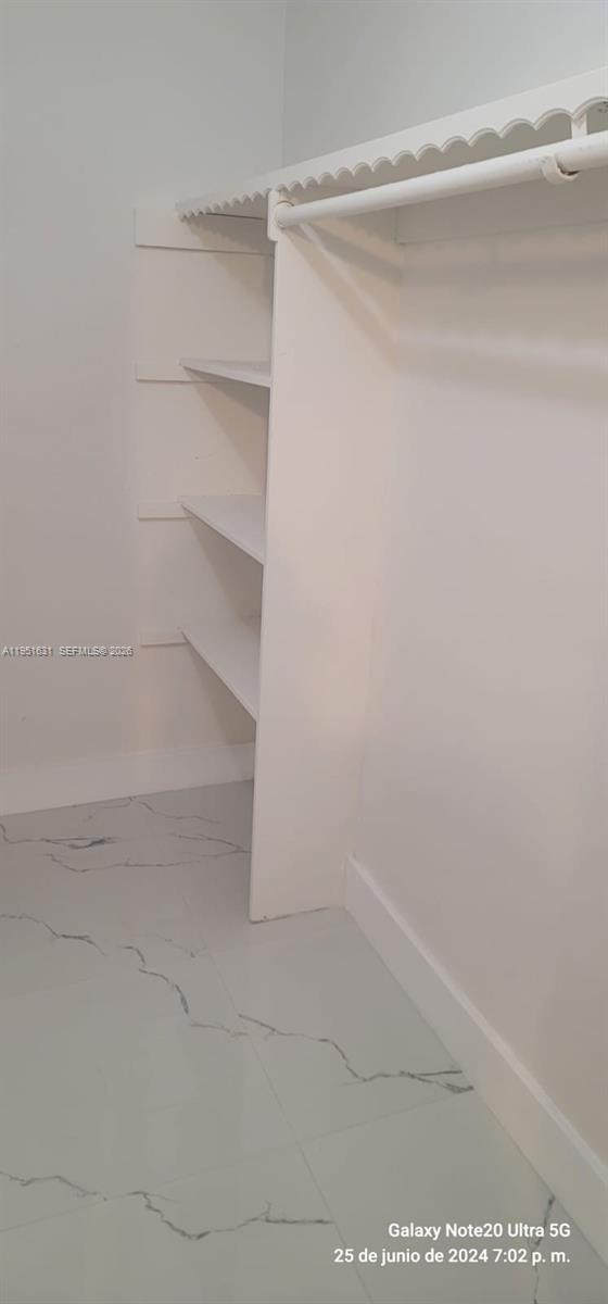 9402 Southwest 77th Avenue, Unit L8 Miami, FL 33156 - Photo 17 of 54 a view of an empty walk in closet