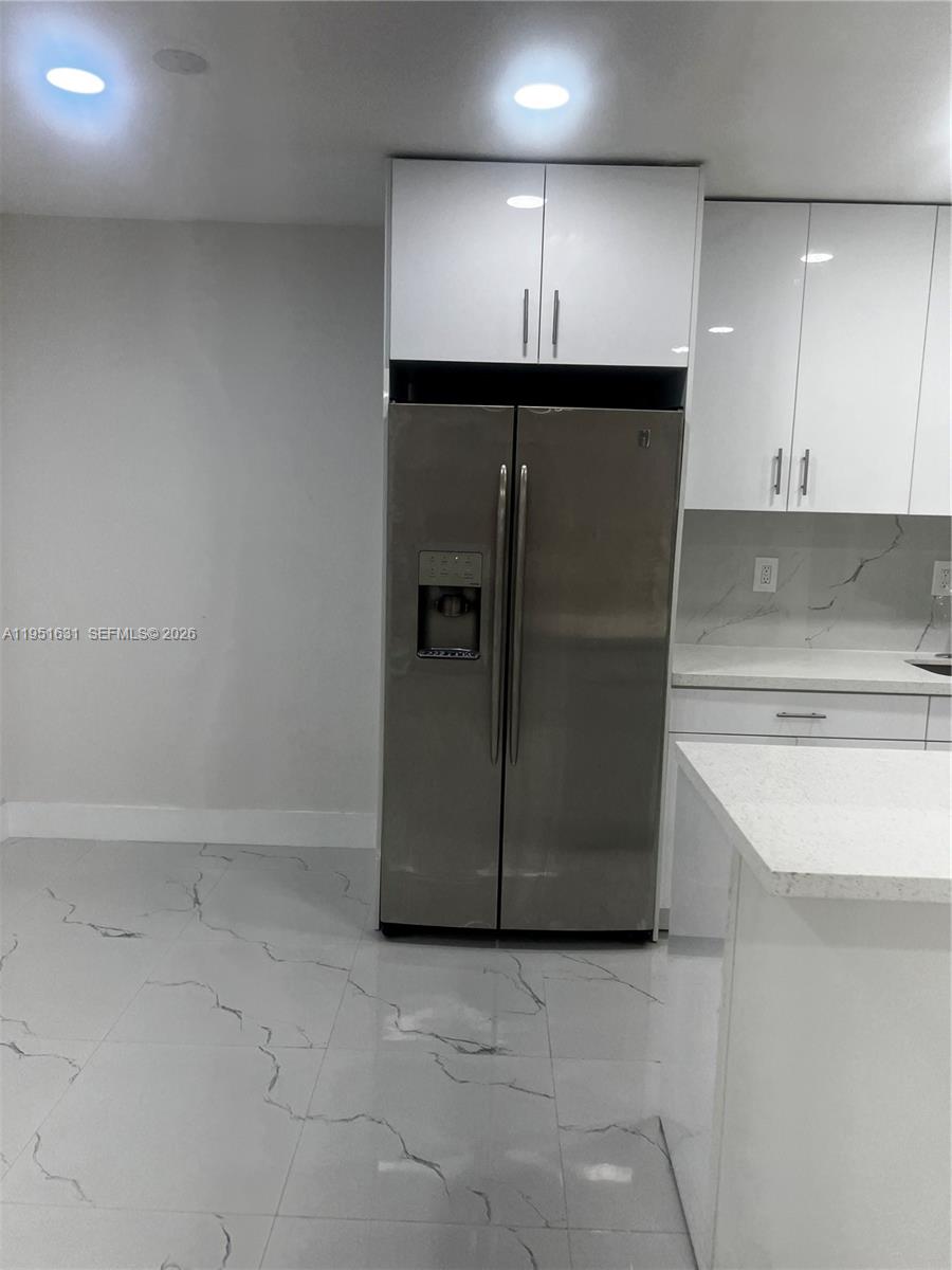 9402 Southwest 77th Avenue, Unit L8 Miami, FL 33156 - Photo 24 of 54 an empty room with wooden floor