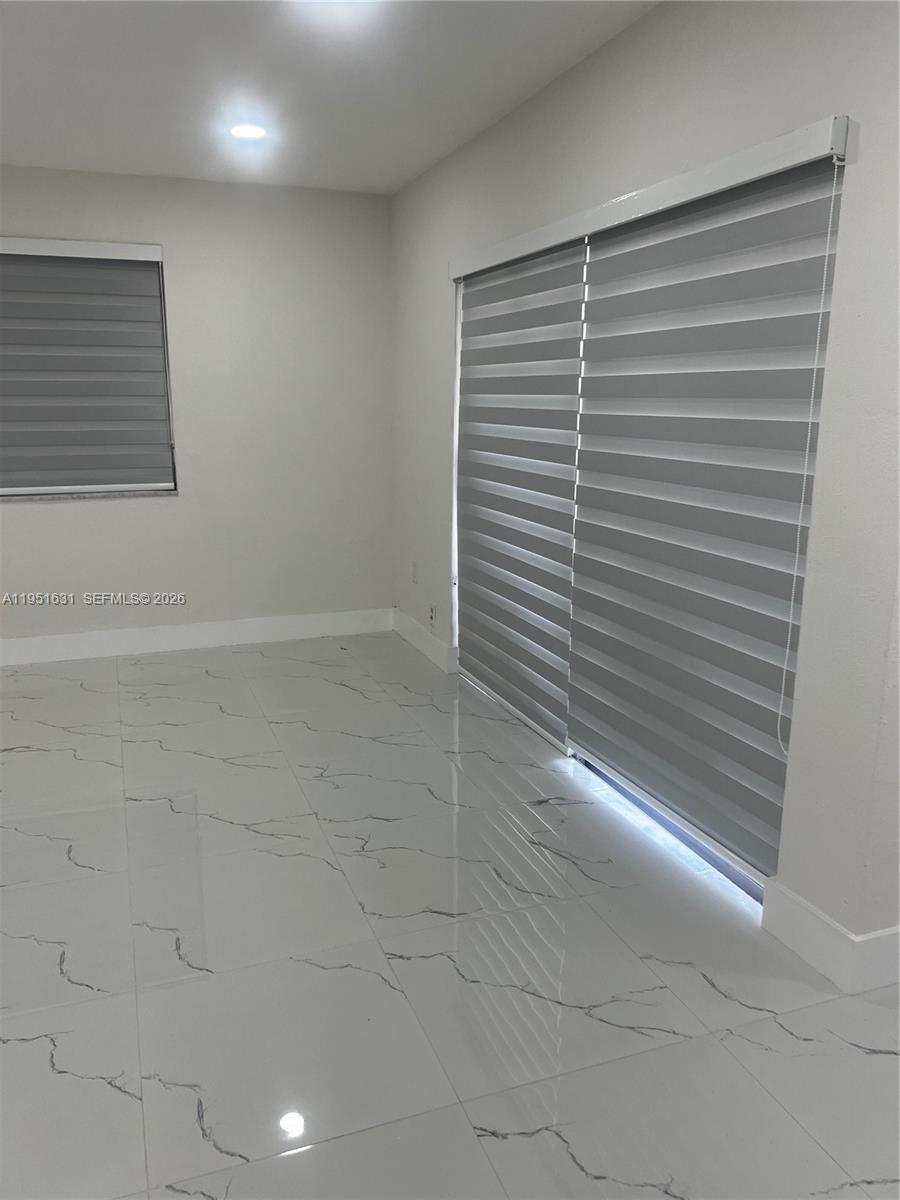 9402 Southwest 77th Avenue, Unit L8 Miami, FL 33156 - Photo 37 of 54 a view of a room with racks on the wall