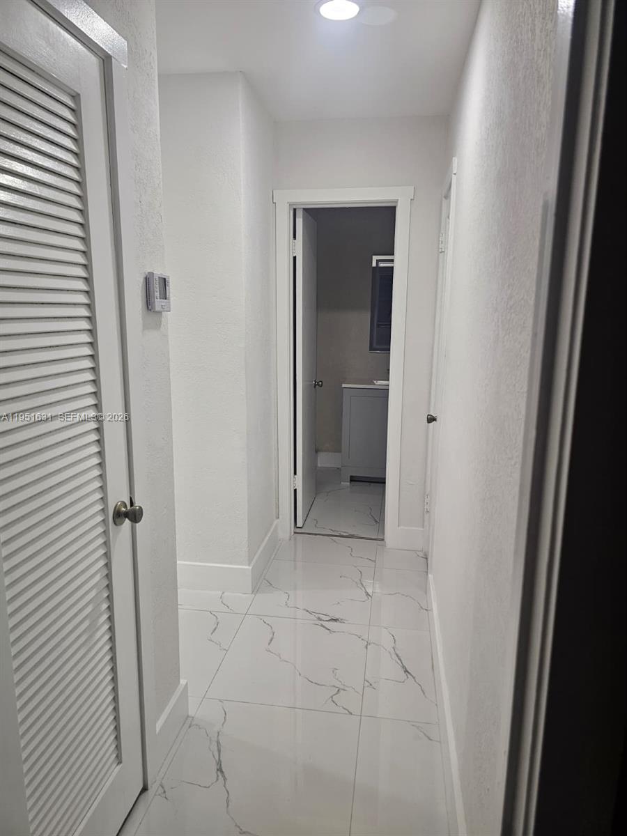 9402 Southwest 77th Avenue, Unit L8 Miami, FL 33156 - Photo 45 of 54 a view of a hallway with a room