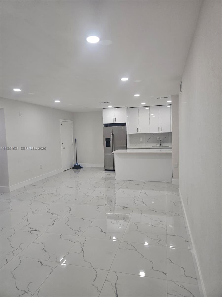 9402 Southwest 77th Avenue, Unit L8 Miami, FL 33156 - Photo 47 of 54 a view of a kitchen with a sink and dishwasher stove top oven with white cabinet