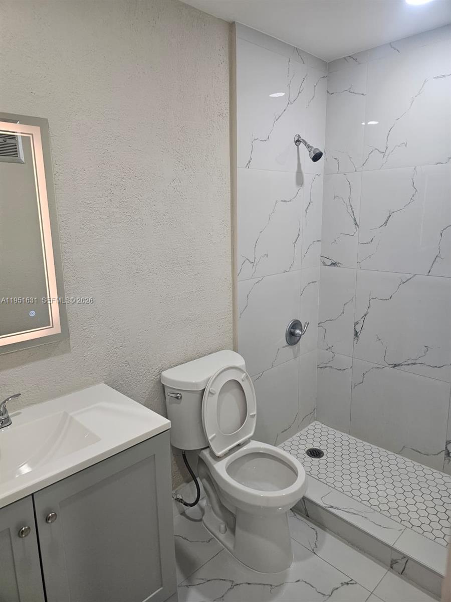 9402 Southwest 77th Avenue, Unit L8 Miami, FL 33156 - Photo 51 of 54 a white toilet sitting next to a bathroom sink