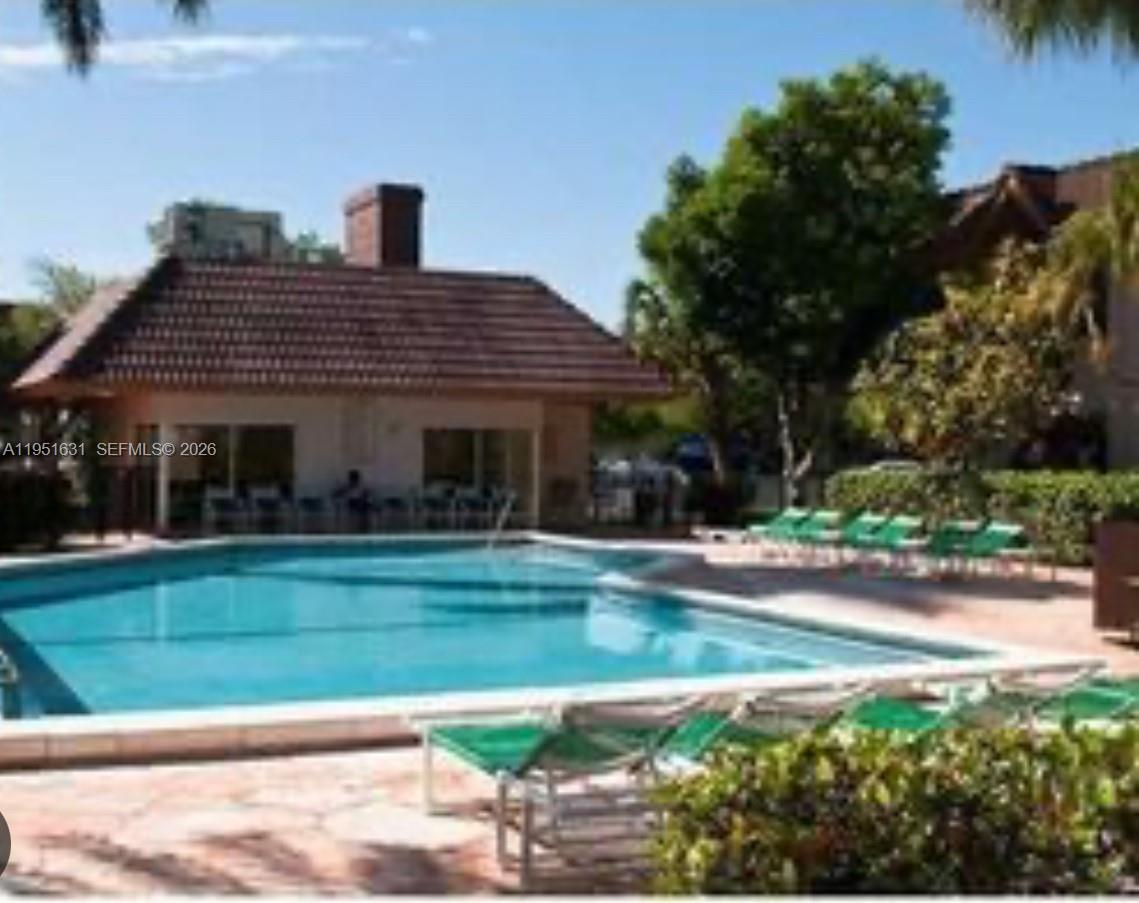 9402 Southwest 77th Avenue, Unit L8 Miami, FL 33156 - Photo 54 of 54 a front view of a house with a yard