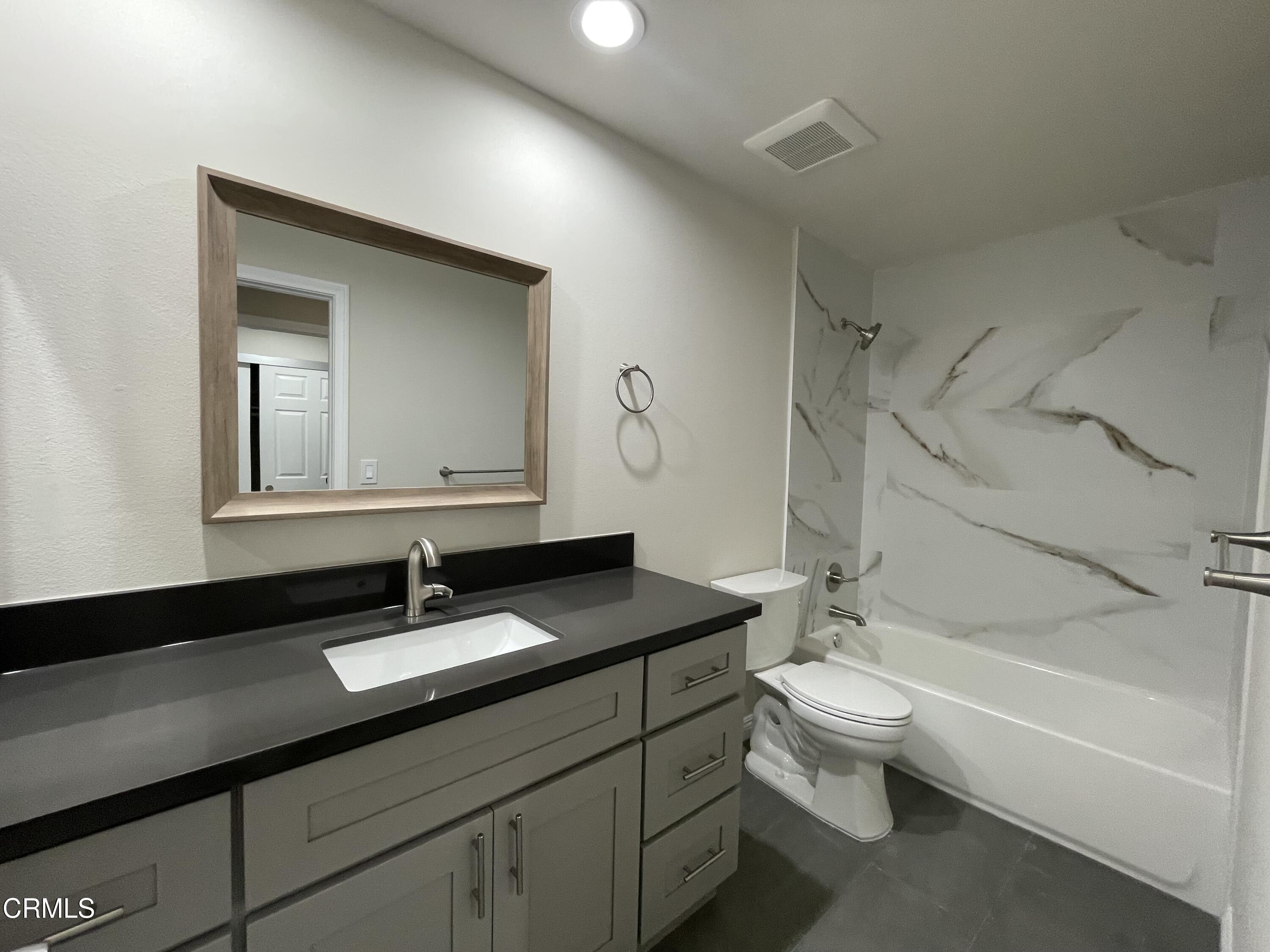 838 Fairview Avenue, Unit N Arcadia, CA 91007 - Photo 13 of 14 a bathroom with a granite countertop sink a toilet and a bathtub