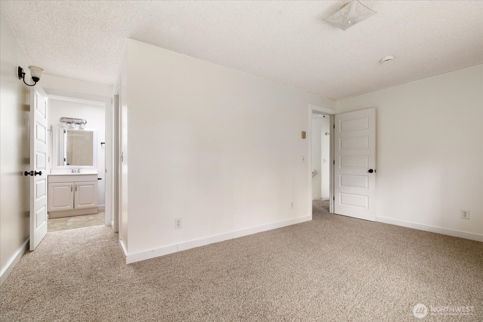 1282 Northwest Lanyard Loop, Unit 2 Oak Harbor, WA 98277 - Photo 14 of 32 a view of a livingroom and a kitchen space with a sink