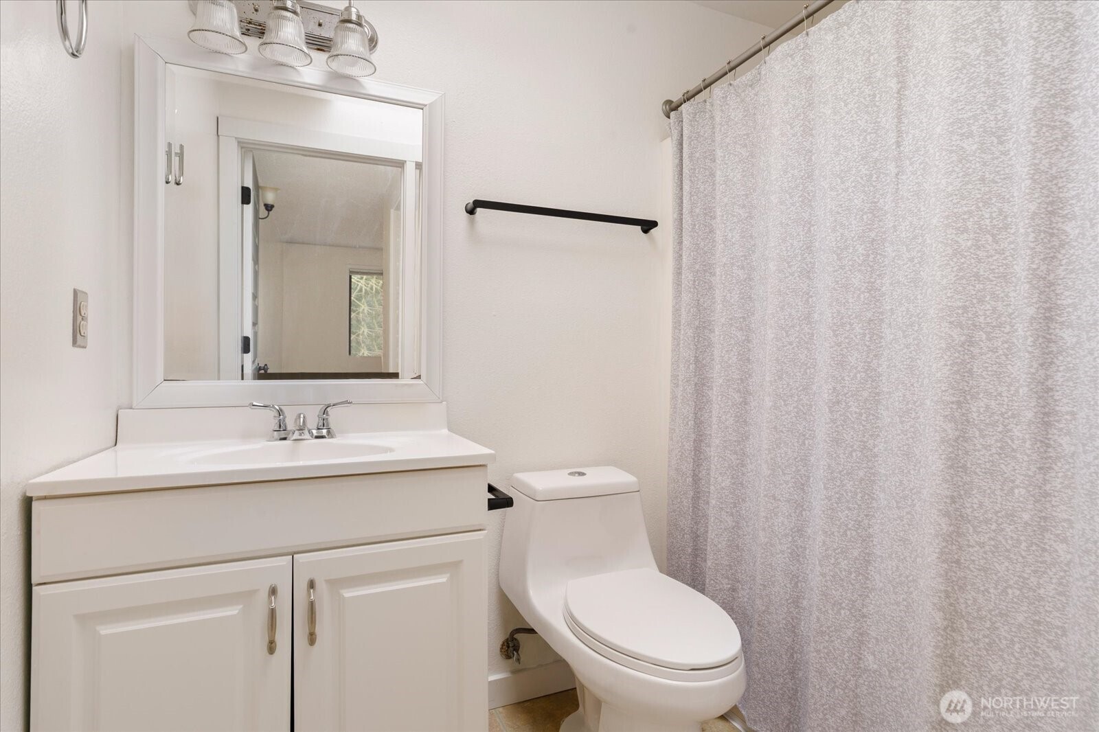 1282 Northwest Lanyard Loop, Unit 2 Oak Harbor, WA 98277 - Photo 17 of 32 a bathroom with a toilet a sink and a mirror