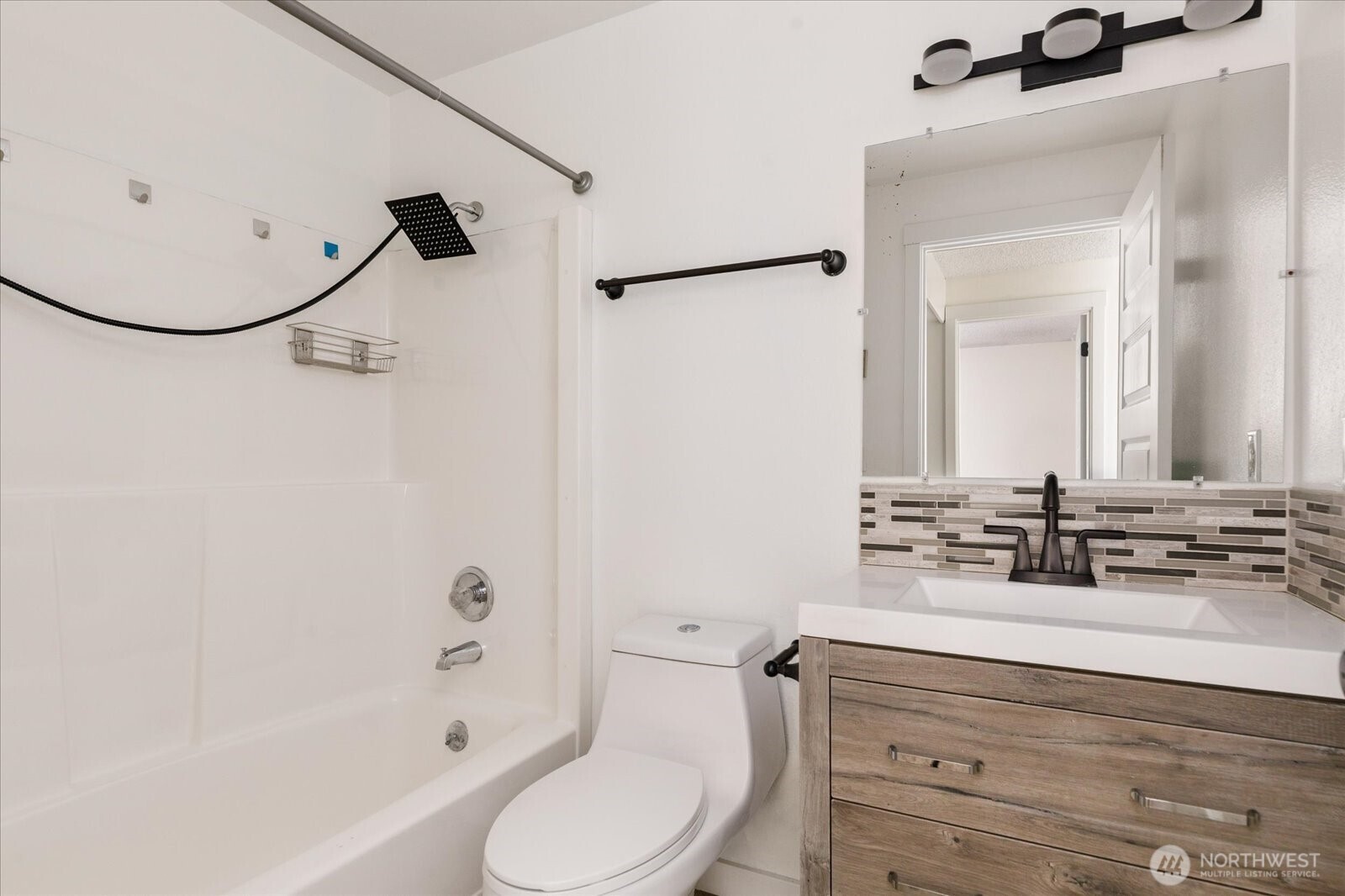 1282 Northwest Lanyard Loop, Unit 2 Oak Harbor, WA 98277 - Photo 19 of 32 a bathroom with a sink mirror vanity and toilet