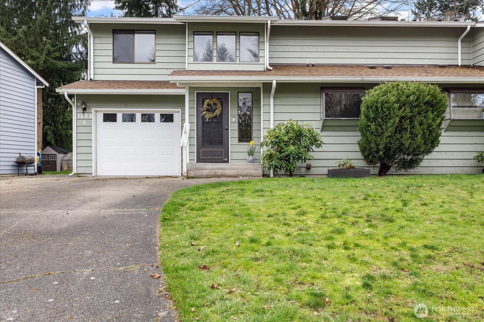 1282 Northwest Lanyard Loop, Unit 2 Oak Harbor, WA 98277 - Photo 2 of 32 a front view of a house with garden