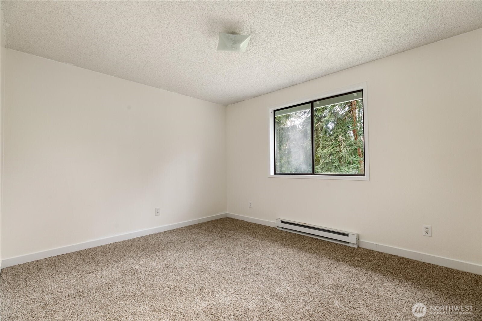 1282 Northwest Lanyard Loop, Unit 2 Oak Harbor, WA 98277 - Photo 22 of 32 an empty room with a window