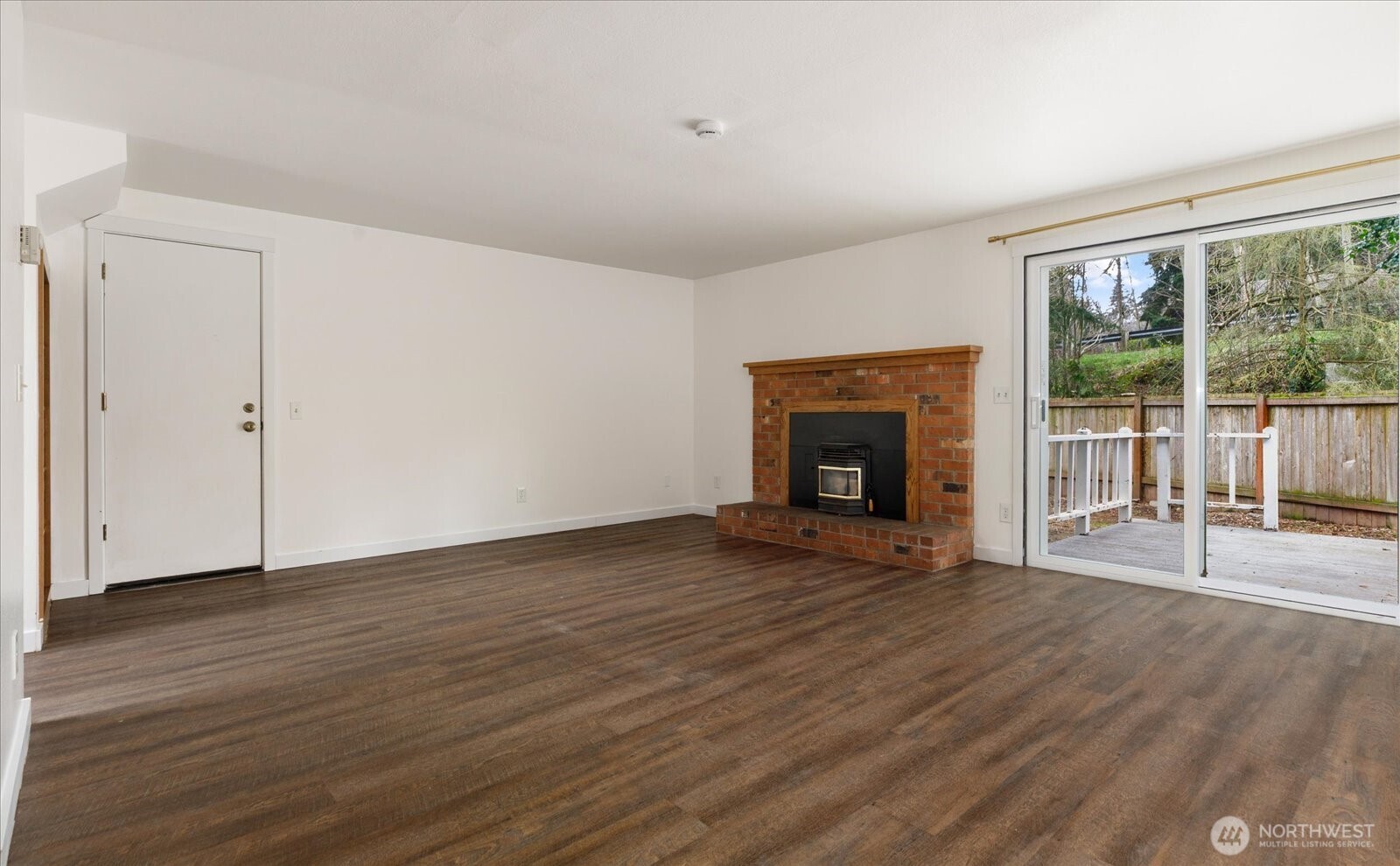 1282 Northwest Lanyard Loop, Unit 2 Oak Harbor, WA 98277 - Photo 6 of 32 a view of an empty room with wooden floor and a window