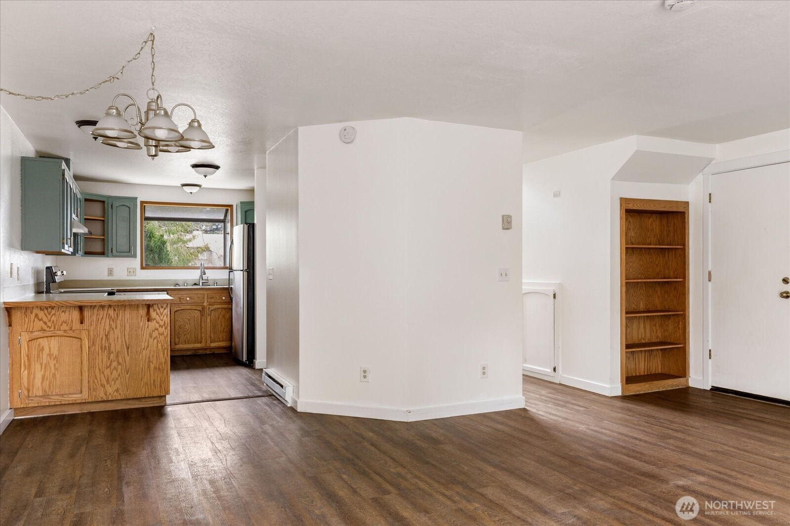 1282 Northwest Lanyard Loop, Unit 2 Oak Harbor, WA 98277 - Photo 7 of 32 a view of a kitchen with a sink and dishwasher a refrigerator with wooden floor