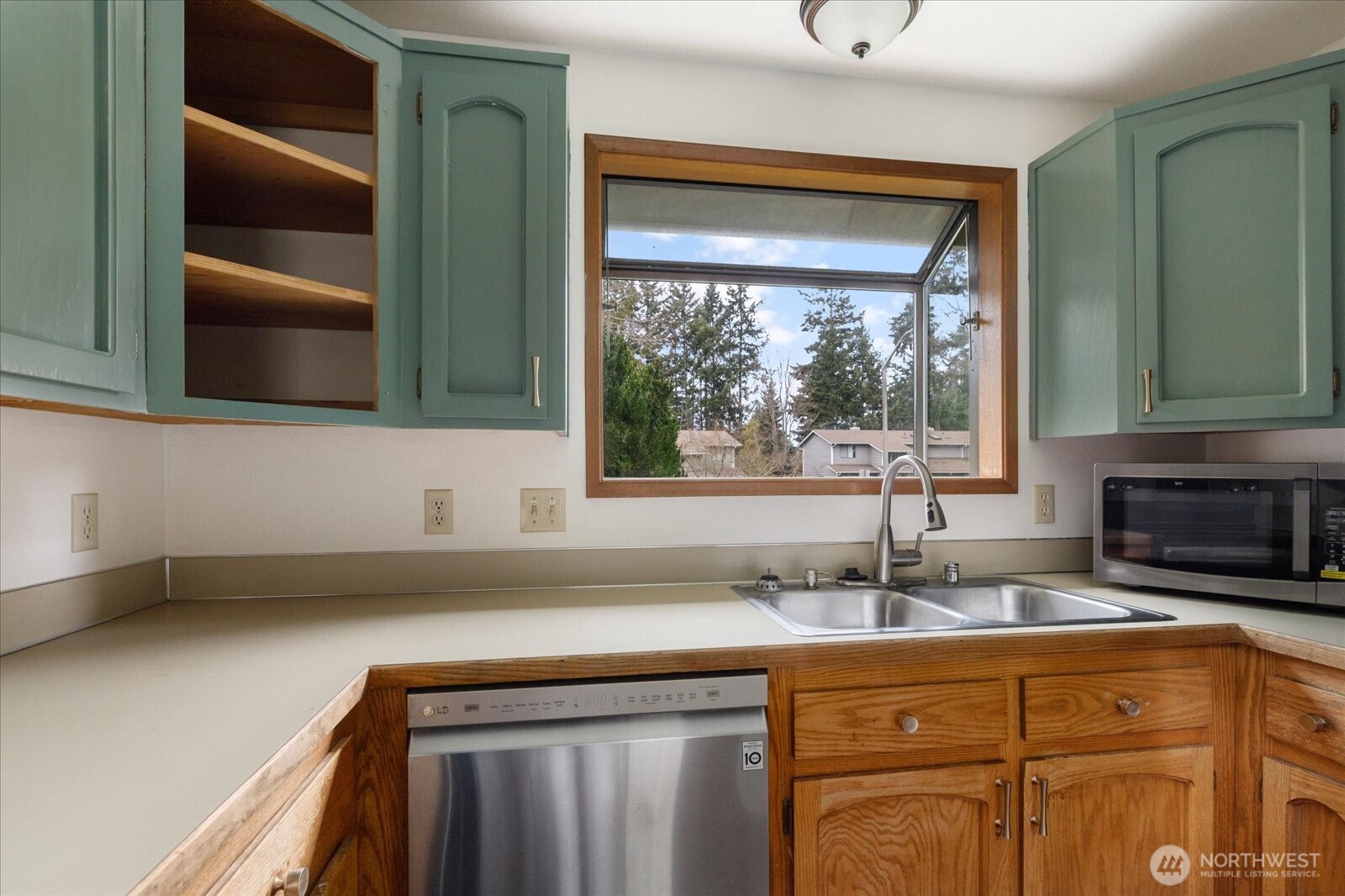1282 Northwest Lanyard Loop, Unit 2 Oak Harbor, WA 98277 - Photo 10 of 32 a kitchen with stainless steel appliances granite countertop a sink and a cabinets