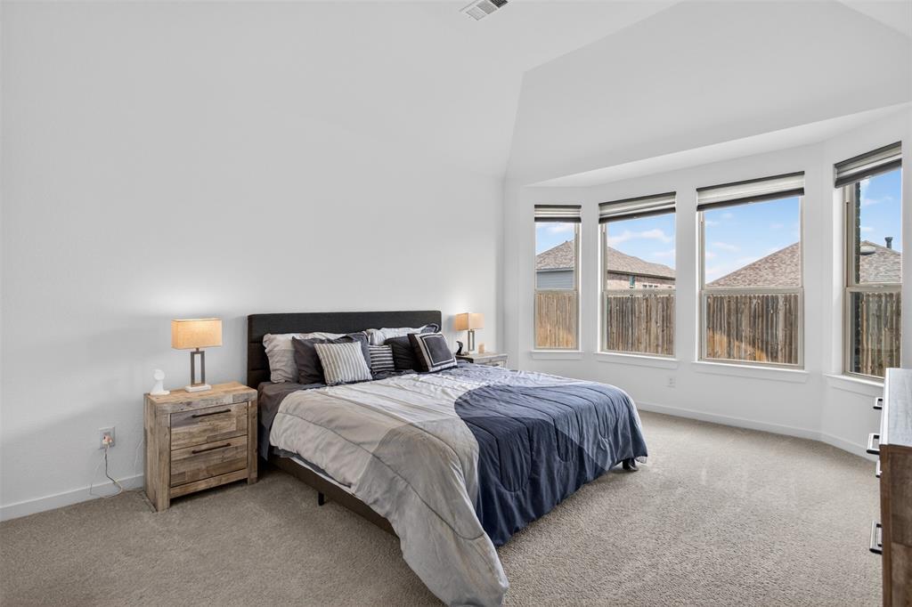 629 Claverton Lane Forney, TX 75126 - Photo 11 of 33 a bedroom with a bed lamp and a large window