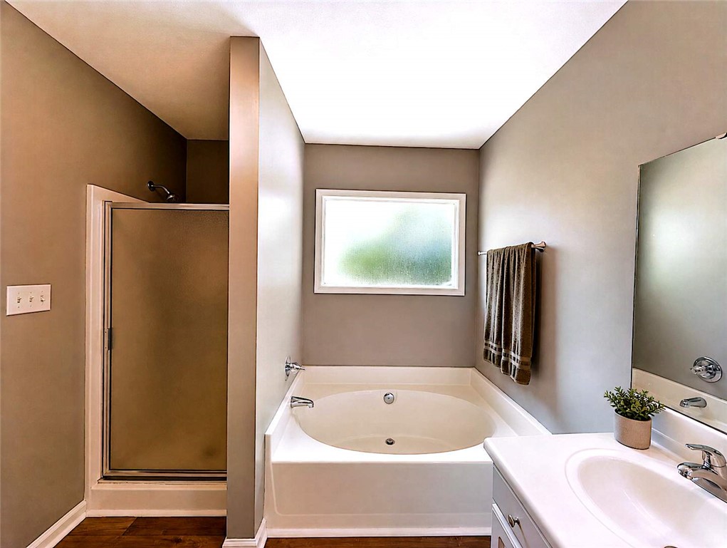 124 Woodbridge Court Anderson, SC 29621 - Photo 11 of 15 This primary bathroom features a shower, a soaking tub, and a vanity for everyday convenience.