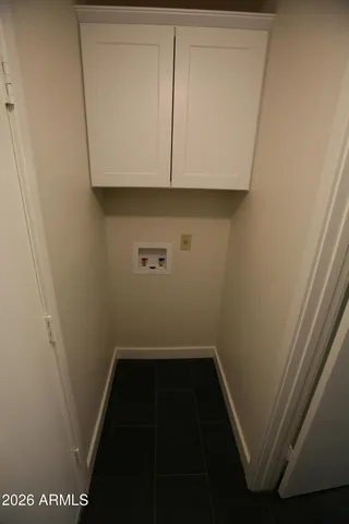 a kitchen with granite countertop sink stove and cabinets