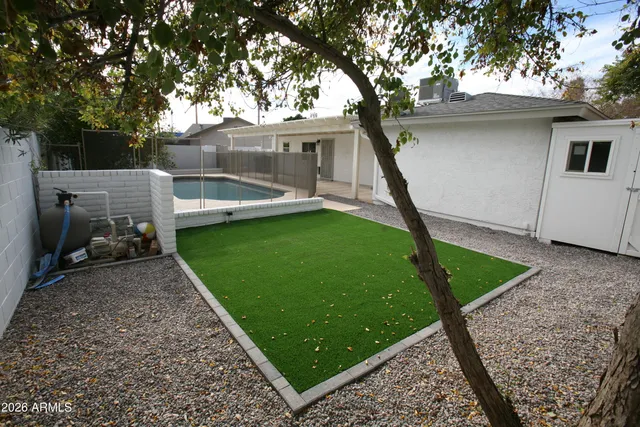 a view of a backyard with sitting area