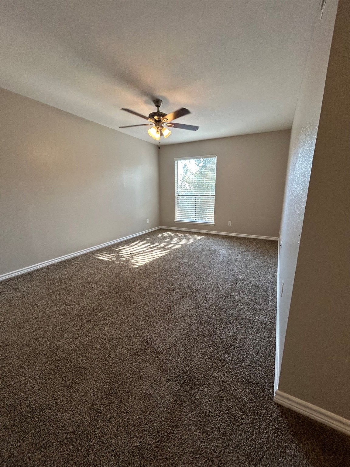 3300 Pebblebrook Drive, Unit 82 Seabrook, TX 77586 - Photo 12 of 13 an empty room with windows and ceiling fan view