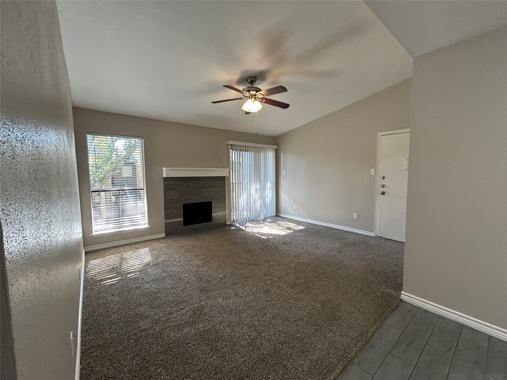 3300 Pebblebrook Drive, Unit 82 Seabrook, TX 77586 - Photo 4 of 13 an empty room with windows and fireplace