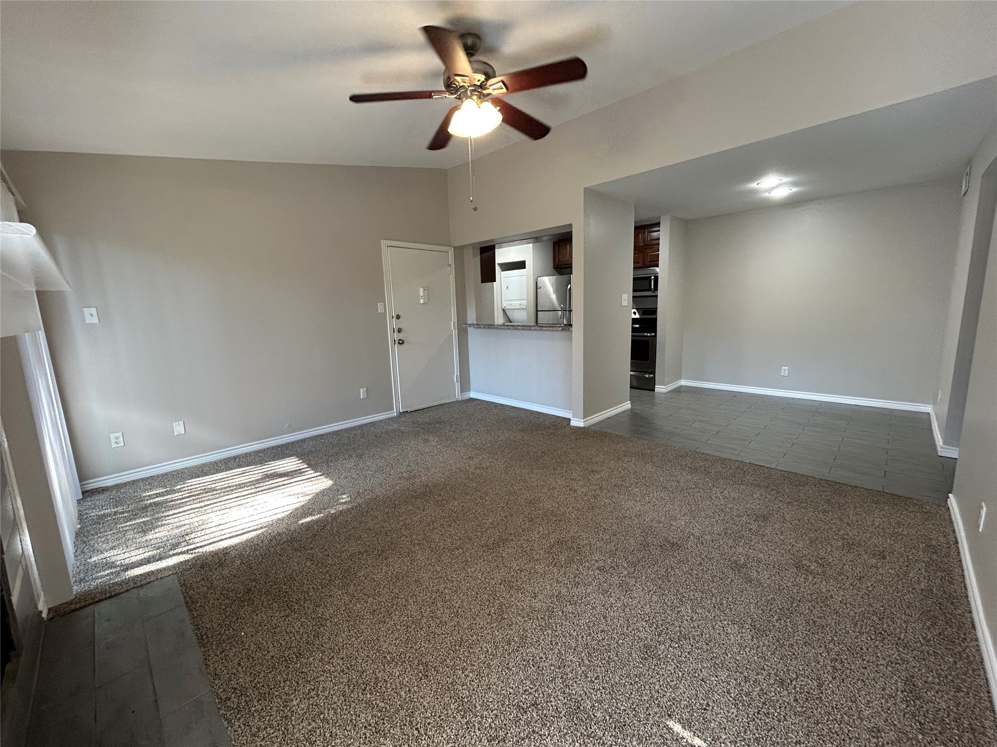 3300 Pebblebrook Drive, Unit 82 Seabrook, TX 77586 - Photo 5 of 13 a view of an empty room and a chandelier fan
