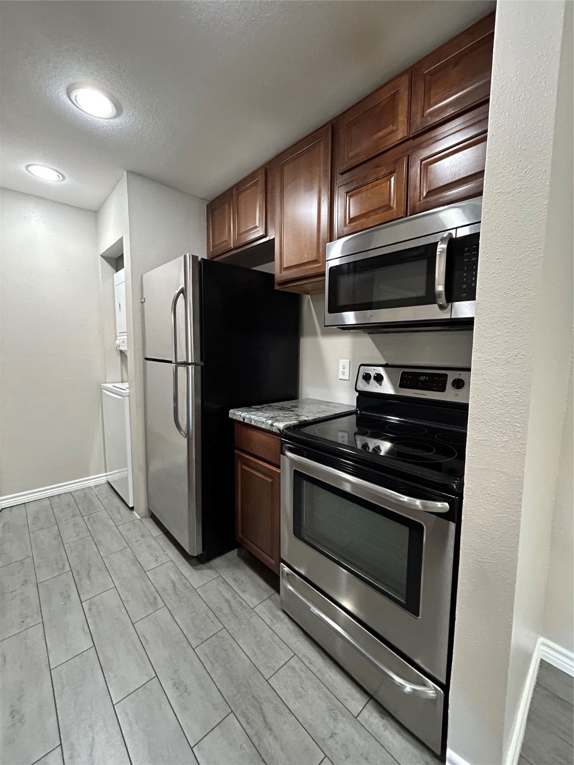 3300 Pebblebrook Drive, Unit 82 Seabrook, TX 77586 - Photo 6 of 13 a metallic refrigerator freezer sitting in a kitchen