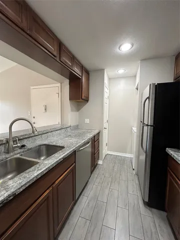 a kitchen with a sink and refrigerator